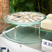 A Front of the House stainless steel riser holding a plate of oysters on ice.