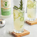 a glass of lemonade with lemons and cucumbers