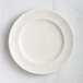 A close-up of a RAK Porcelain ivory flat plate with a floral design.