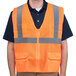 A Cordova orange high visibility safety vest with reflective stripes on a man.