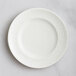 A white RAK Porcelain flat plate with an embossed floral design.