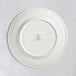 A RAK Porcelain ivory flat plate with an embossed crown logo on the rim.