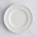 A RAK Porcelain ivory flat plate with an embossed floral pattern on the rim.