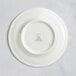 A white RAK Porcelain saucer with a circular design.