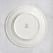 A white RAK Porcelain plate with an embossed design of flowers.