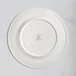 A white RAK Porcelain flat plate with an embossed floral design.