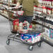 A black metal supermarket shopping cart with an 8.5 cubic foot capacity, filled with groceries.