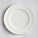 A RAK Porcelain ivory flat plate with an embossed rim.