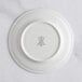 A white RAK Porcelain plate with an ivory embossed crown logo.