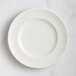 A white RAK Porcelain flat plate with an embossed floral design.