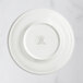 A RAK Porcelain ivory flat plate with an embossed crown logo.
