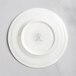 A white RAK Porcelain flat plate with an embossed design.