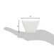 A hand holding a small white square porcelain sauce cup.