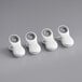 Three white OXO Good Grips magnetic clips on a grey surface.