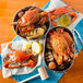 A bowl of Chesapeake blue crab and corn on the cob with a lemon half and nutcracker.