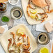 A plate of live female blue crab and lemons on a table.