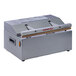 An ARY VacMaster impulse bag sealer with a red label on a counter.