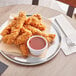 a plate of fried chicken strips and sauce