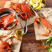 A bowl of live Chesapeake blue crabs on a table with lemons.