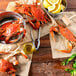 A bowl of lemons and a group of live Chesapeake blue crabs on paper.