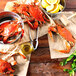 A group of live Chesapeake blue crabs on paper next to a bowl of lemons.