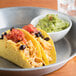 A plate of tacos with guacamole and a bowl of Regal Salt-Free Taco Seasoning.