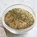 A bowl of Regal Canadian Chicken seasoning with herbs and spices.