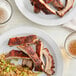 A plate of ribs and rice with Regal Homestyle Pork Rub seasoning.