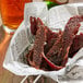 A basket of meat in a newspaper.