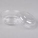 A close-up of a Dart clear plastic container with a lid.