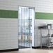 A Lavex reinforced strip door on a metal shelf in a room with a white and green tile floor.