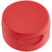 A red round container with a 38/400 red inverted squeeze bottle lid on a table.