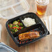 A Choice plastic container with rice, broccoli, and meat in it with a fork.