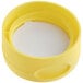A yellow plastic lid with a white pressure sensitive liner.