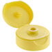 A yellow plastic squeeze bottle lid with a hole.
