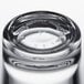 A close up of a Libbey stackable beverage glass filled with water on a table.