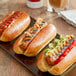 A plate of Upton's Natural Updog plant-based hot dogs with ketchup and vegetables.