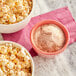 A bowl of popcorn with Carnival King Spicy Cayenne Popcorn Seasoning powder.