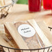 A package of Avery Matte White Round Labels on a basket of cookies on a table.