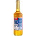 A Torani passion fruit syrup bottle with a blue label.