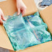 A person opening a box with Pregis AirSpeed Renew cushion plastic bags inside.