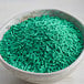 a bowl of green sprinkles