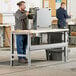 A man working on a Lavex heavy-duty workbench.