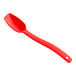 A red plastic spoon with a long handle.