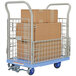 A blue Vestil plastic platform truck with mesh sides filled with boxes.