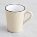 A white stoneware mug with a handle.