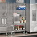 A metal Steelton wire shelving unit in a kitchen with food items on it.