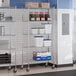 A chrome 5-shelf wire shelving unit with casters, used for storage in commercial or industrial settings.