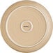 A close up of an Acopa Harvest Tan matte stoneware plate with a small circular design and a white rim.