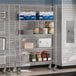 A Steelton metal wire shelving kit in a school kitchen with food items on the shelves.